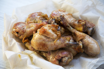 Roasted chicken legs on paper, closeup