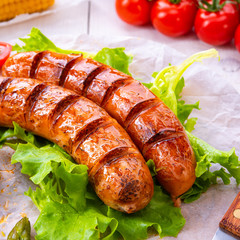grilled krakauer sausage with boiled corn and green salad