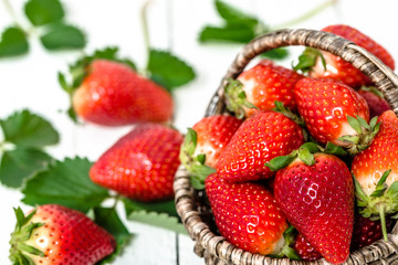 Fresh strawberries in the basket, red berry fruits on farmer market