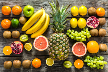 Tropical fruit on table, farm fresh organic fruits on market, flat lay, overhead - obrazy, fototapety, plakaty