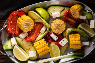 Grilled vegetables, corn cobs, zucchini, red pepper.