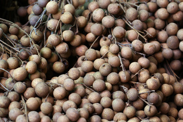 Bunch of organic raw brown Longan at fresh market in the summer of Thailand, riped fruit backgrounds