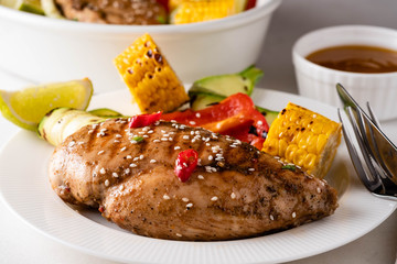 Chicken fillet with corn, pepper and zucchini.