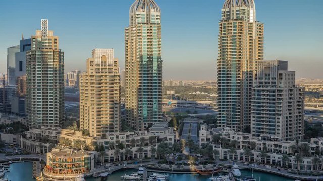 Dubai Marina skyscrapers aeral timelapse, port with luxury yachts and marina promenade