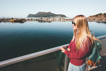 Young pretty woman walking at seaside alone Traveling lifestyle concept blonde girl with backpack weekend vacations outdoor