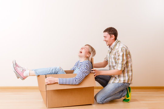 Photo of blonde in cardboard box and man