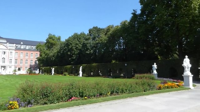 Historic garden full of withe statues at residence castle (in German: Kurf&uuml;rstliche Palais) in Trier, Germany