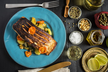 Grilled Salmon with Vegetables Served on Blue Plate. Healthy Meal.