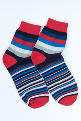 A pair of striped socks. Stripes color: red, blue, white, gray and black