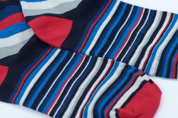 A pair of striped socks. Stripes color: red, blue, white, gray and black