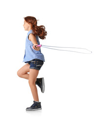 Cute little girl playing with jumping rope on white background