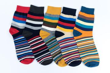 Several pairs of striped socks. The stripes are of all colors.