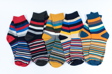 Several pairs of striped socks. The stripes are of all colors.