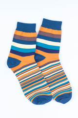 A pair of striped socks. Stripes color: mustard, turquoise, blue and white . 