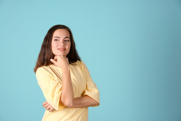 Obraz premium Portrait of beautiful smiling woman on color background
