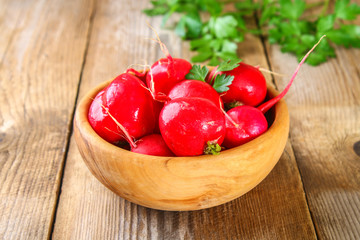 Fresh young radish on wooden old table boards