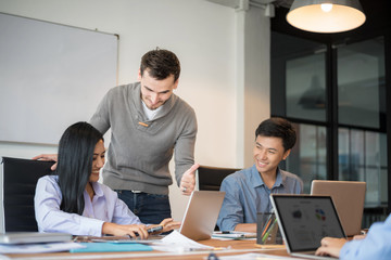 Business people are discussing about their work. Happy boss is talking to employee at workplace. Setup studio shooting.