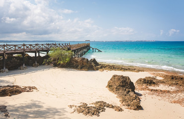 Wooden pier at Prison island near Zanzibar,  Beautiful turquoise water and white sand near Zanzibar, Tanzania
