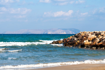 Beautiful view of the Mediterranean Sea from the sandy beach of the island of Crete.