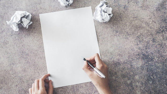 Hand Writing On Blank Paper With Crumpled Paper Ball