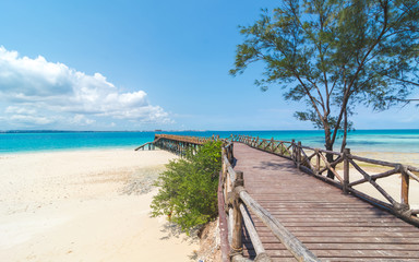 Wooden pier at Prison island near Zanzibar,  Beautiful turquoise water and white sand near...