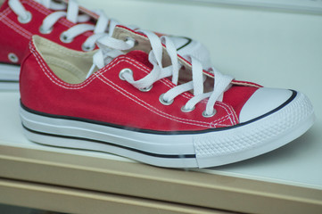 closeup of red sneakers in fashion store showroom