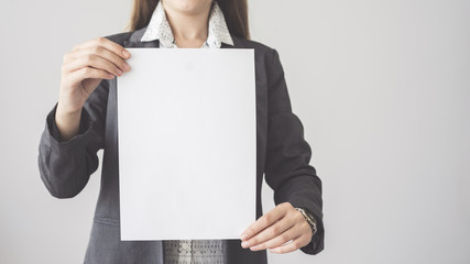  Woman holding blank vertical advertisement card