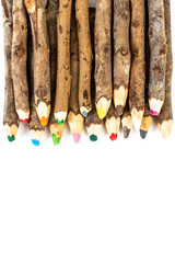 Handmade wooden color pencils on white background.