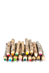 Handmade wooden color pencils on white background.