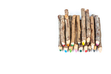 Handmade wooden color pencils on white background.
