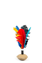 Handmade shuttlecock toy with colourful feathers on white background