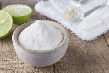 baking soda and lemon on wooden table