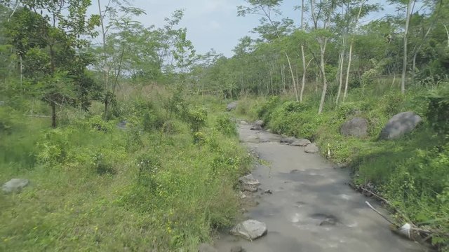 Small river aerial footage in rain forest, Ledok Sambi village, Yogyakarta, Indonesia. April 2018