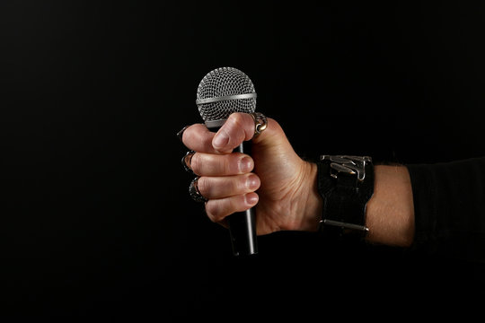 Man Hand With Microphone Isolated On Black