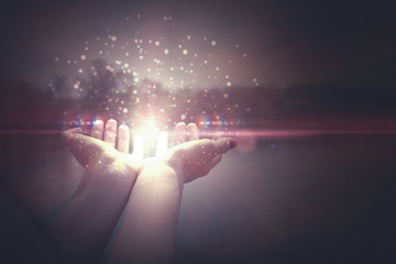 Hands holding magic particles. Magic out of hand. Heat. Fabulously mysterious
