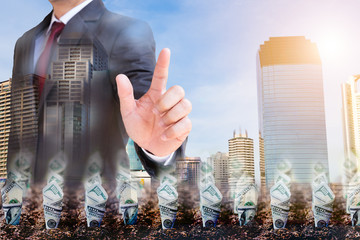 Dollar bill plant growth from ground over Businessmen shaking hands on city background. Double exposure. Business finance Partnership  and investment concept