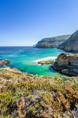 Tasman Peninsula, Tasmania, Australia: Scenic coastline of rocky cliff Tasman arch with old stone formations dramatic structures near blue wild ocean perfect hiking landscape countryside Port Arthur