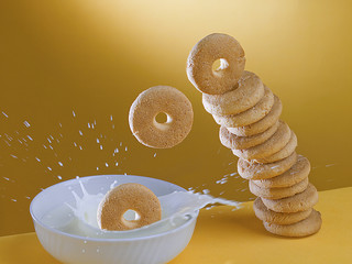 pila di biscotti e  tazza di latte su fondo giallo