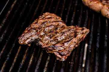 Group grilled ribeye beef steaks on the grill outdoor, background. barbecue season concept, bbq copy space, summer