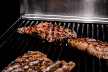 Group grilled ribeye beef steaks on the grill outdoor, background. barbecue season concept, bbq copy space, summer