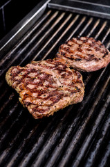 Group grilled ribeye beef steaks on the grill outdoor, background. barbecue season concept, bbq copy space, summer