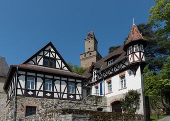 Obraz premium View on half timbered houses and castle tower in the historic old town of Kronberg im Taunus, Hesse, Germany