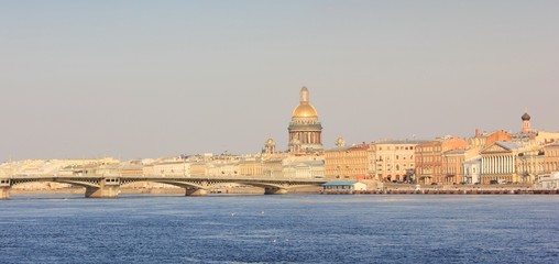 Panoramic Skyline of Saint Petersburg Cityscape in Russia. City Scenic View across Neva River with Historic Bridge and Saint Isaac's Cathedral Architecture on Sunny Summer Day Background before Sunset