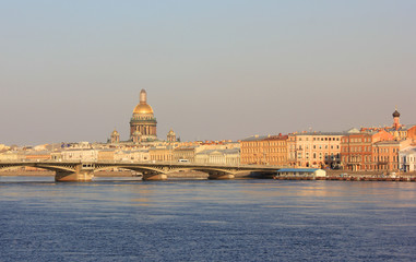 Fototapeta na wymiar Saint Petersburg City Skyline with St. Isaac's Cathedral and Draw Bridge in Russia. Cityscape Close Up Over the River Water at Dusk Sky Background before Sunset. St. Petersburg Touristic Wallpaper.