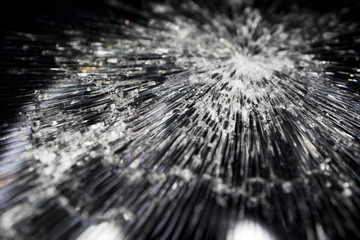 Cracked smart phone screen close-up. Broken glass texture background with cracks, macro