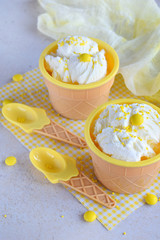 Homemade vanilla ice cream on marble background. White frozen delicious dessert in individual jello vase.