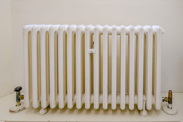 Vintage white metal radiator painted in white