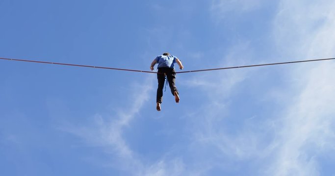 Man relaxing on tight rope 