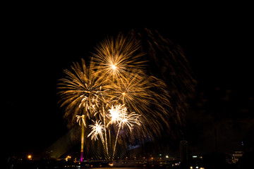 Beautiful golden firework display for celebration happy new year and merry christmas in the night sky, bangkok city, thailand
