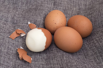 group of medium-hard boiled eggs with their husks